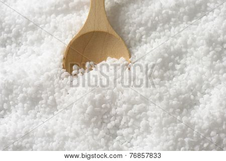 pure sea salt with immersed wooden spoon