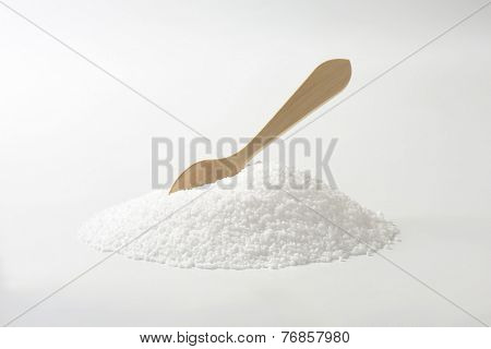 side view of salt heap with immersed wooden spoon