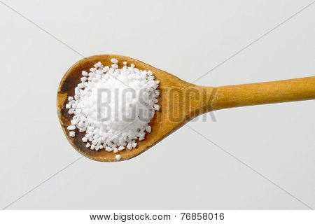 wooden spoon with the whit coarse salt