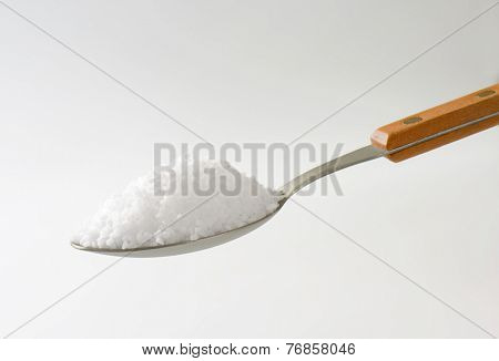 teaspoon with portion of coarse salt