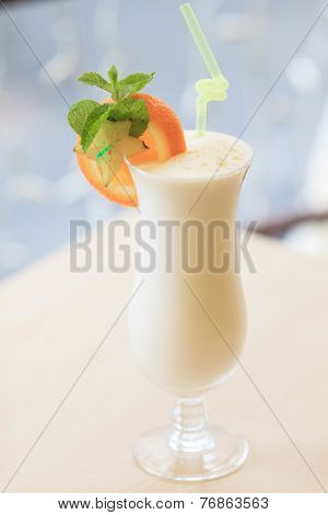 Milk cocktail with orange and carom