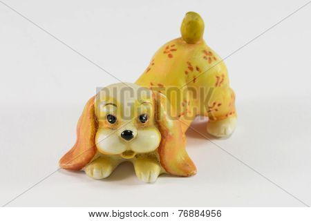 Statuette Of Dog Sitting On White Background
