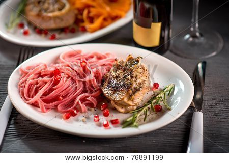 Pasta with steak on wooden table
