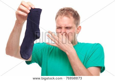 Man Holding Smelly Socks And Clogged Nose