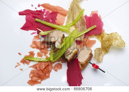 Closeup of a skewer of pork jowls.