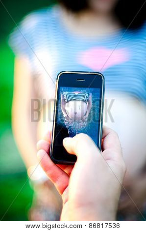 Happy Pragnant Women Outdoor In The Garden Making Photo With Husband
