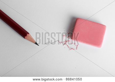 Eraser and pencil on paper background