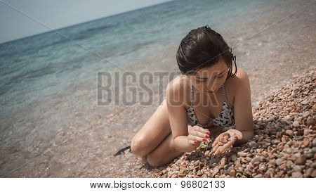 young girl the teenager on a sea beach