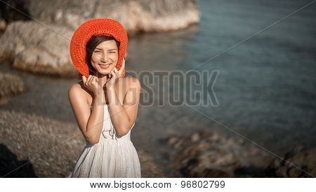 Hot beautiful woman in colorful sunhat and dress