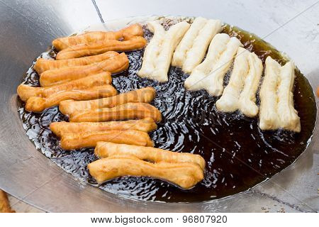 Deep frying bread stick or popularly known as You Tiao, a popular Chinese delicacy.