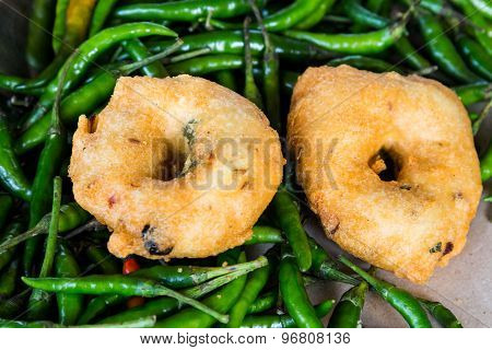 Uluntu Vadai with green chili pepper, a popular Southern Indian deep fried snack