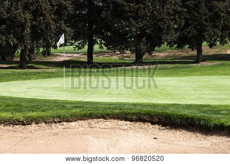 15 Th Hole Flagstick On A Putting Green In A Golf Course.