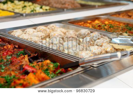 Meatballs and stewed vegetables in marmites