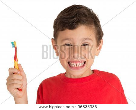 Young boy happily holding a tooth brush ready to brush his teeth