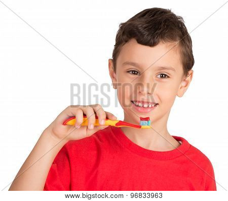Young boy happily holding a tooth brush ready to brush his teeth