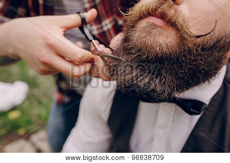 two bearded men shave