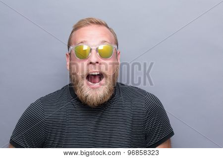 Surprised bearded man in sunglasses
