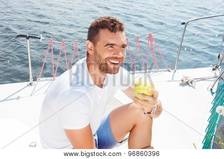 Upbeat man holding apple