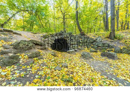 Stone grotto in the autumn park