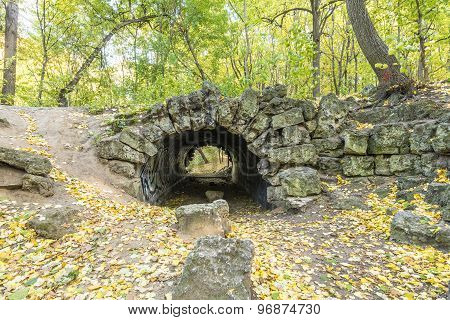 Stone grotto in the autumn park