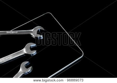 Chrome Fork Wrenches On The Tablet Display Black Isolated
