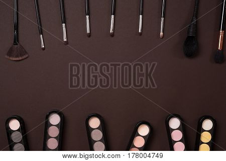 brush for makeup, eye shadow, view from above. Still life. On a brown background. Copy space