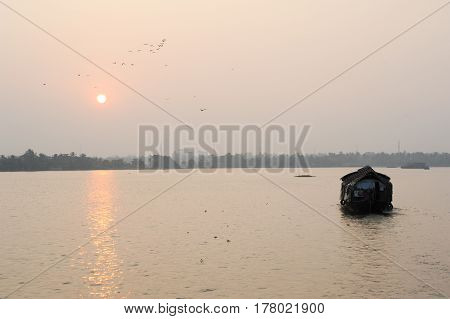 Alleppey, India - 21 January 2015: Traditional Indian houseboat cruising near Alleppey on Kerala backwaters
