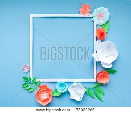 Square Frame With Color Paper Flowers On The Blue Background. Flat Lay. Nature Concept