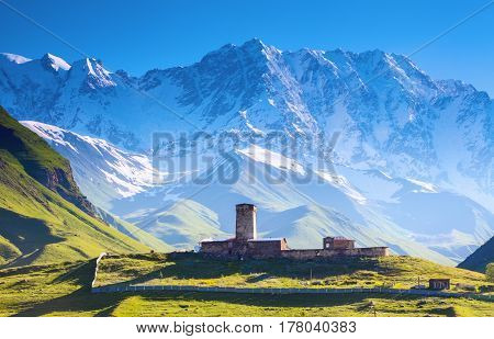 A fascinating view on Ushguli village at the foot of snow-capped Mt. Shkhara. Location place Lamaria Church Jgrag Upper Svaneti Georgia Europe. Happy lifestyle. Beautiful universe.