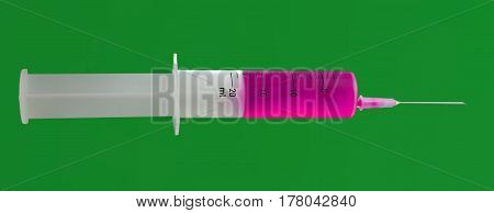 Isolated syringe with needle with purple liquid on green background