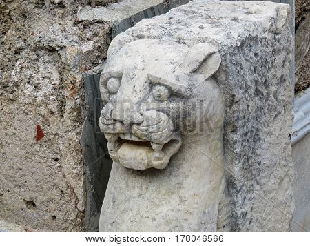 Ancient stone statue of a lion on the ruins of the ancient city of Side