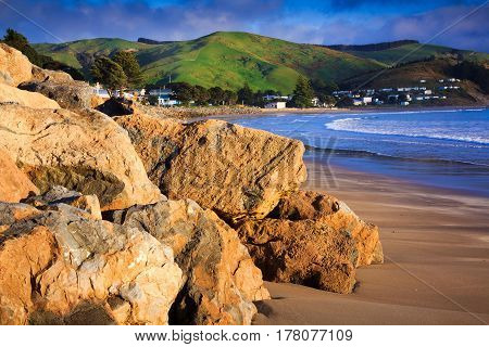 sea and green hills landscape, location - Castlepoint, North Island, New Zealand