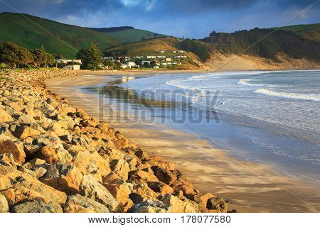 sea and green hills landscape, location - Castlepoint, North Island, New Zealand