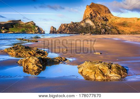 sea, rocks and hills landscape, location - Castlepoint lighthouse, North Island, New Zealand
