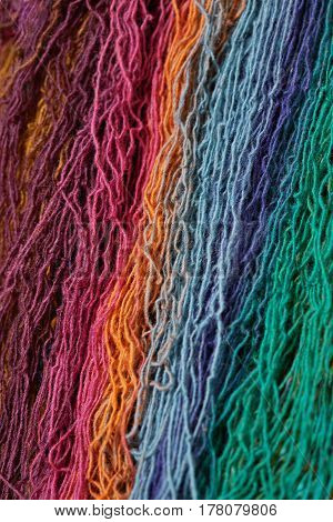 Multi-colored wool yarn for knitting. Vertically arranged threads.