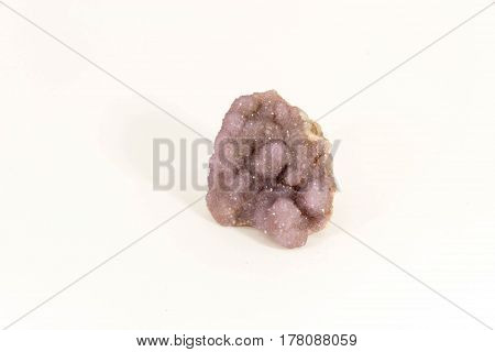 Beautiful semiprecious stone small amethyst druse on a white background