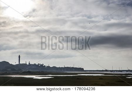 El Rompido lighthouse and marina at sunrise from marshlands Huelva Spain