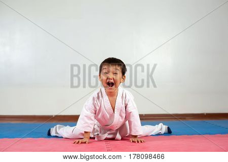 Little boy yells a battle cryFighting position active lifestyle practicing fighting techniques
