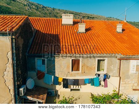 Dubrovnik Old Town, Croatia. Tiled roofs of houses. Church in the city. City View from the wall.
