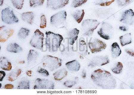 Stone pavement powdered with fresh snow, Russia