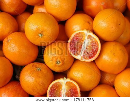 Oranges And An Orange Cut In The Stall Of Greengrocer