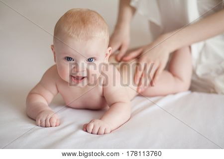 Mom makes the baby massage.Baby care. Mother care