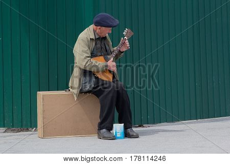 Kiev Ukraine - May 03 206: An elderly man makes a living playing a balalaika