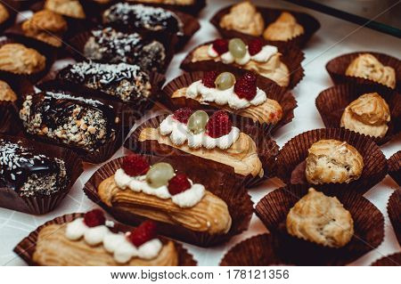 Eclairs traditional french dessert. candybar on a white table