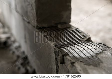 A wall of aerated concrete blocks close up shot in studio being repaired