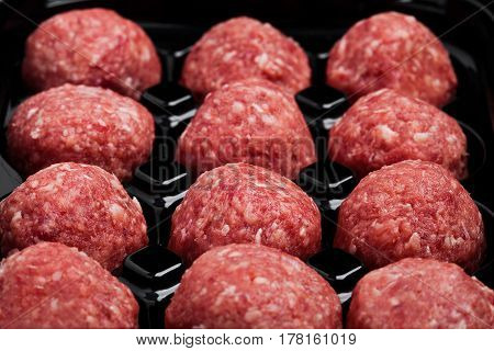 Raw Beef Meatballs In Black Plastick Tray
