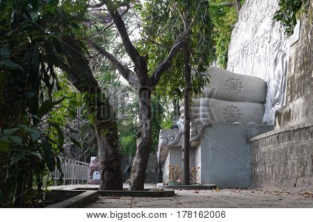 The lying Buddha at a necropolis with the put symbol of the sun on a foot of legs