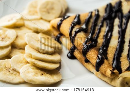 breakfast pancake crepe with banana wooden background