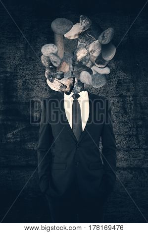 Rock headed man on concrete background, close up