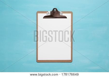 Blank clipboard on pastel blue color background with copy space, minimal style, flat lay.